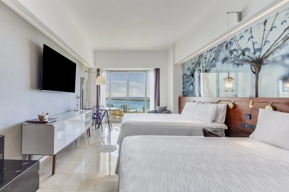 Two-bed oceanfront premium room with balcony view at Live Aqua Cancun.