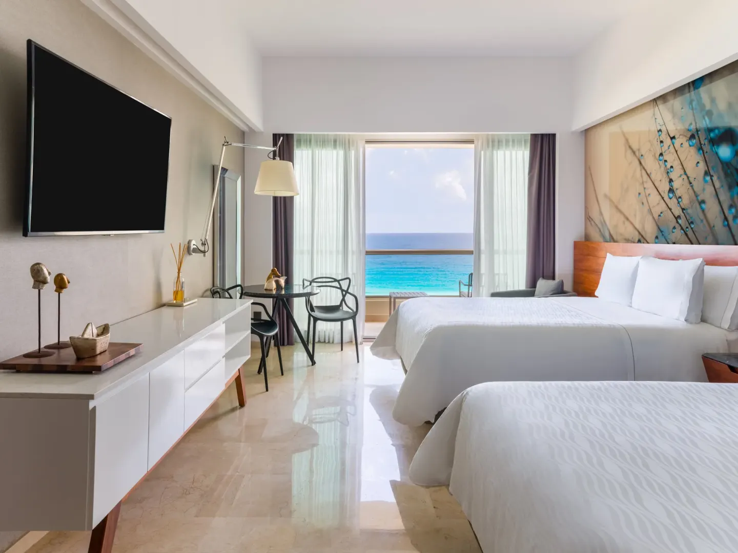Oceanfront two-bed premium room with TV and turquoise sea view at Live Aqua Cancun.