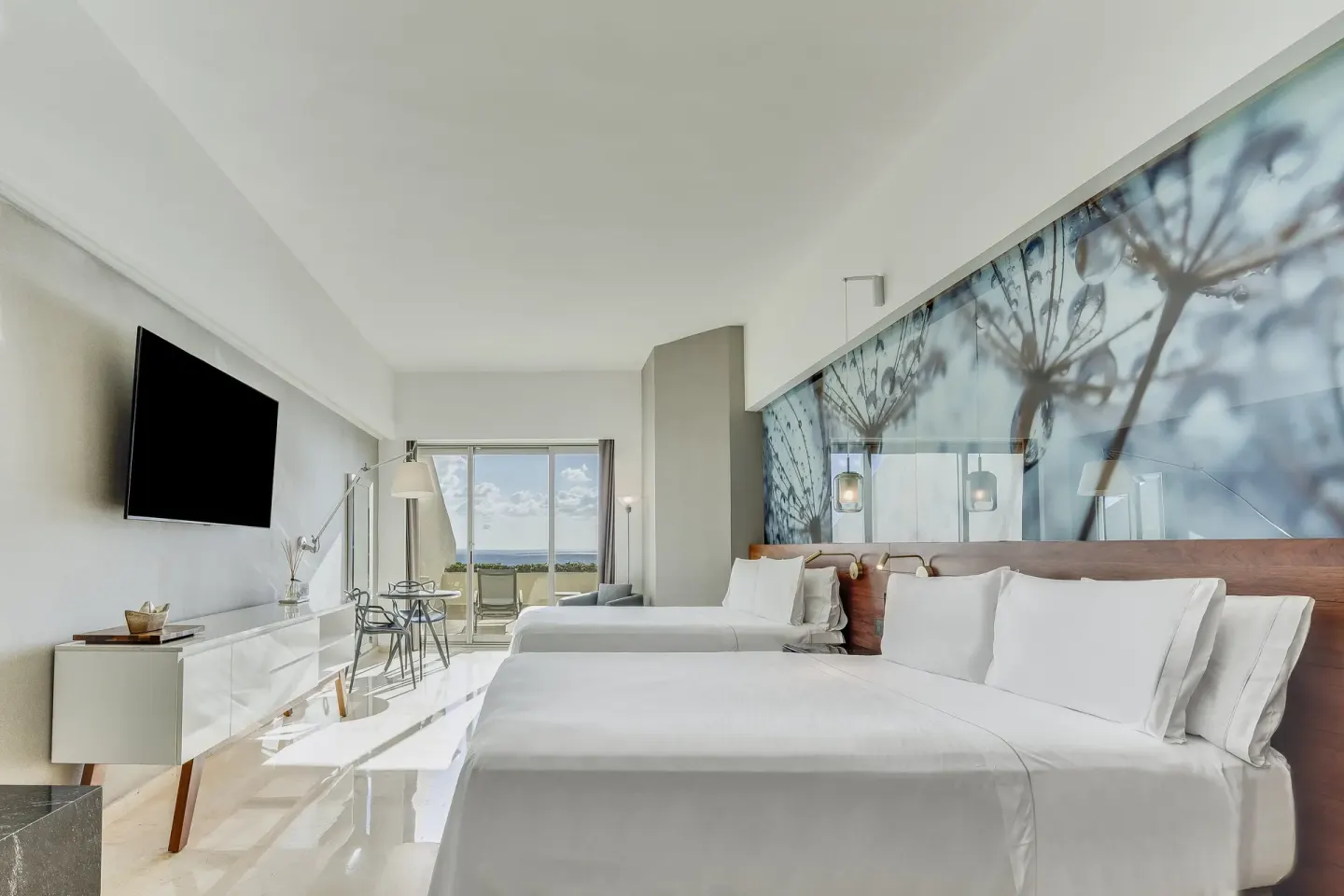Premium Room with two beds, wall mural, TV, and oceanfront terrace at Live Aqua Cancun.