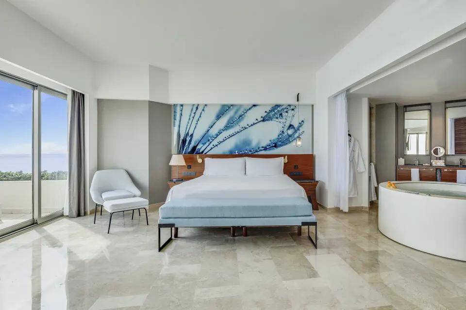 Oceanfront suite with king bed, balcony, and jetted tub at Live Aqua Cancun.
