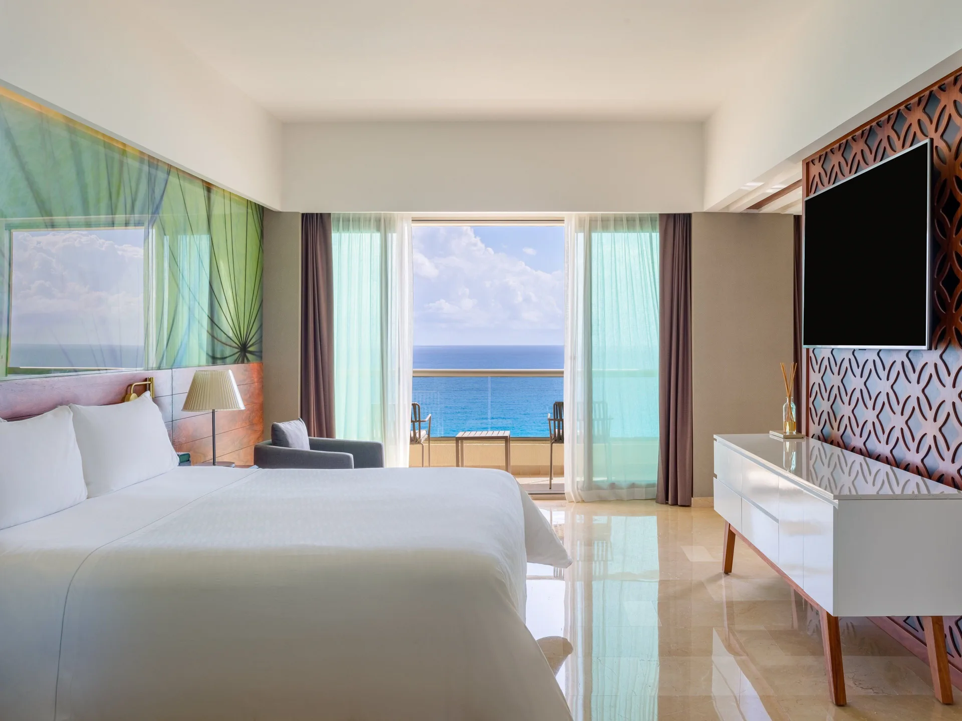 Suite Tierra king bed with ocean-facing balcony at Live Aqua Cancun.