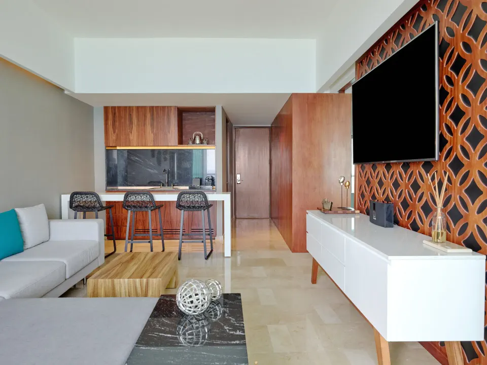 Suite Tierra living room with kitchenette and TV at Live Aqua Cancun.