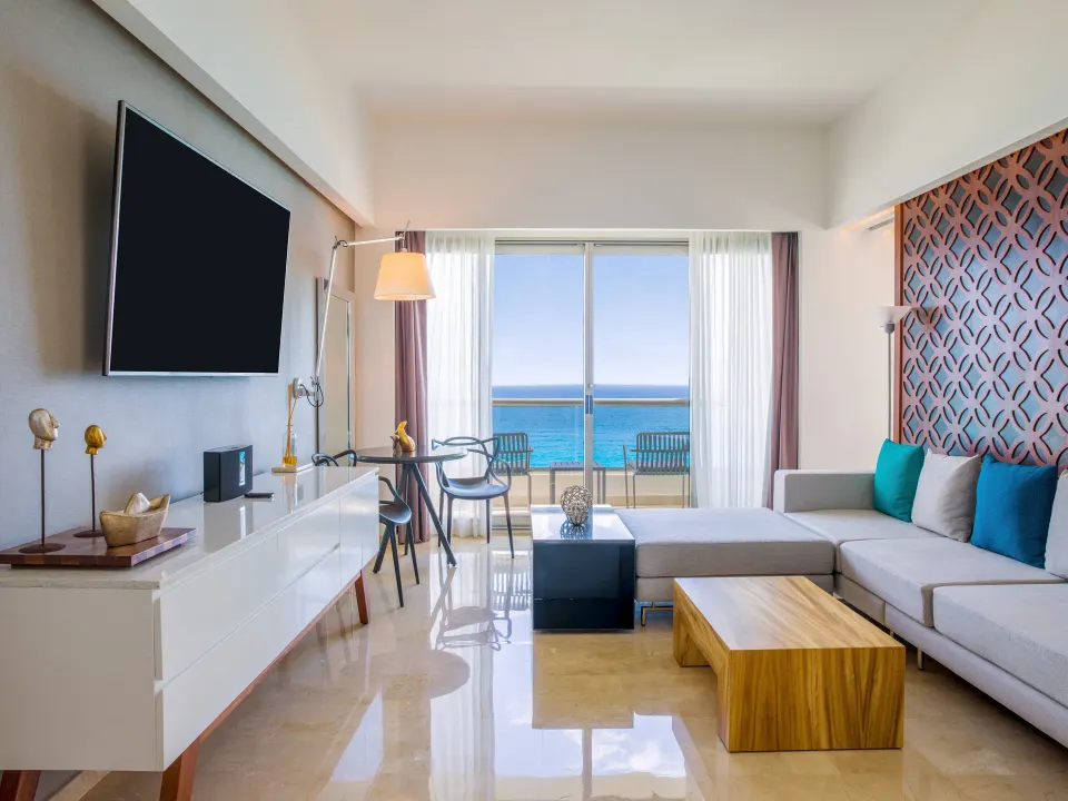 Suite Tierra lounge with sectional sofa and ocean balcony at Live Aqua Cancun.