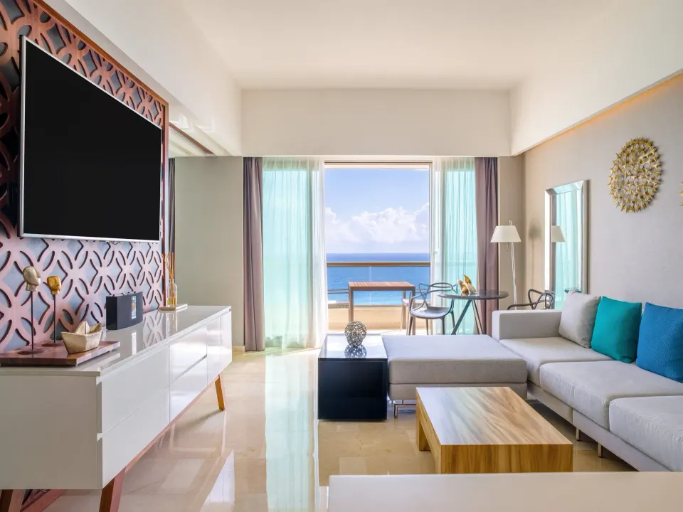 Suite Tierra sitting area with ocean-view balcony at Live Aqua Cancun.