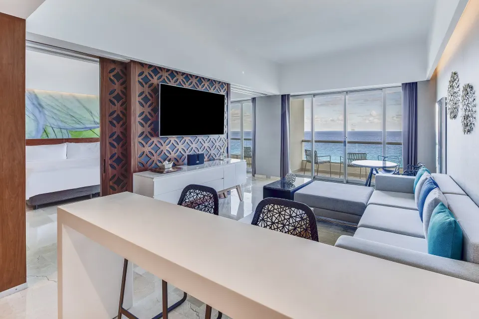 Oceanfront Viento Suite living room with bedroom and balcony at Live Aqua Cancun.