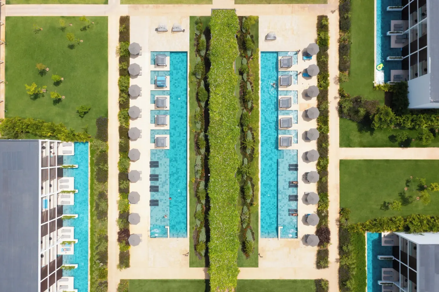Aerial view of long pools, lawns, and paths at Live Aqua Punta Cana.