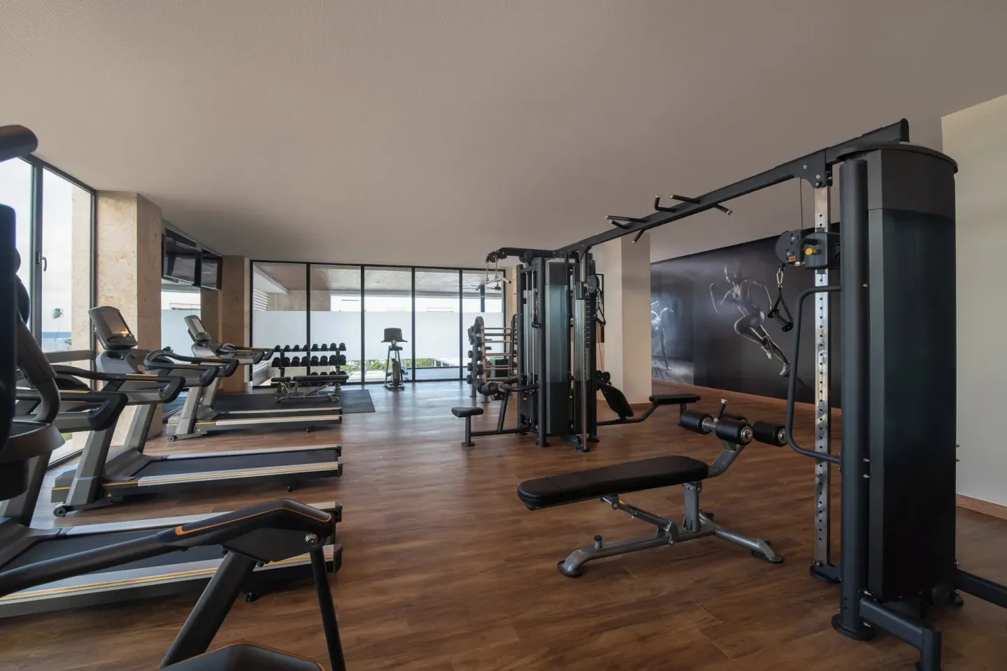 Fitness center with treadmills, weights and cable machines at Live Aqua Punta Cana.