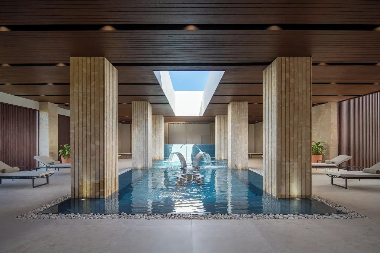 Indoor spa pool with fountains and loungers at Live Aqua Punta Cana.