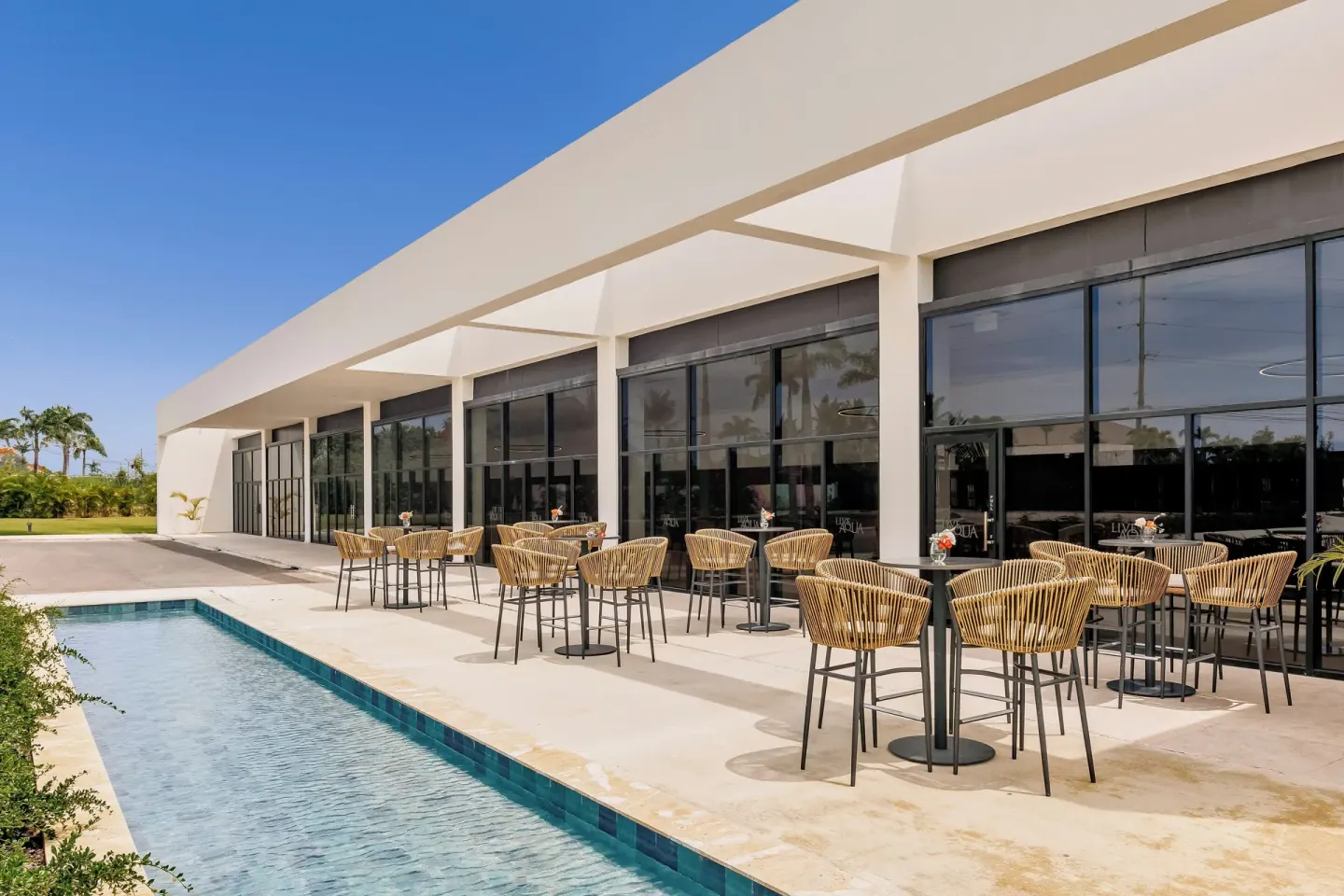 Outdoor terrace seating beside a narrow pool at Live Aqua Punta Cana.