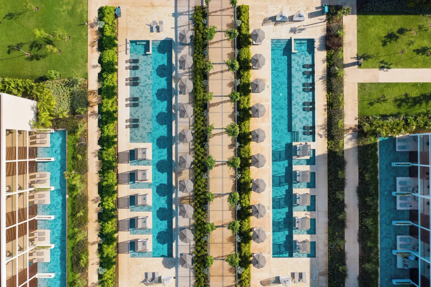 Overhead view of long pools, cabanas, umbrellas, and paths at Live Aqua Punta Cana.