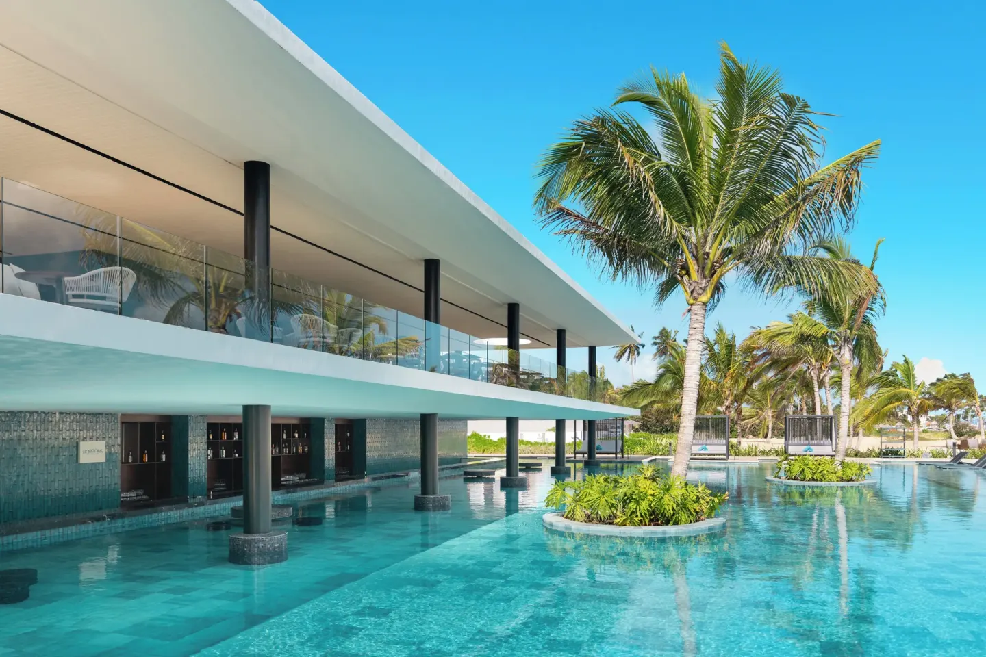 Pool with palm island and swim-up bar area at Live Aqua Punta Cana.