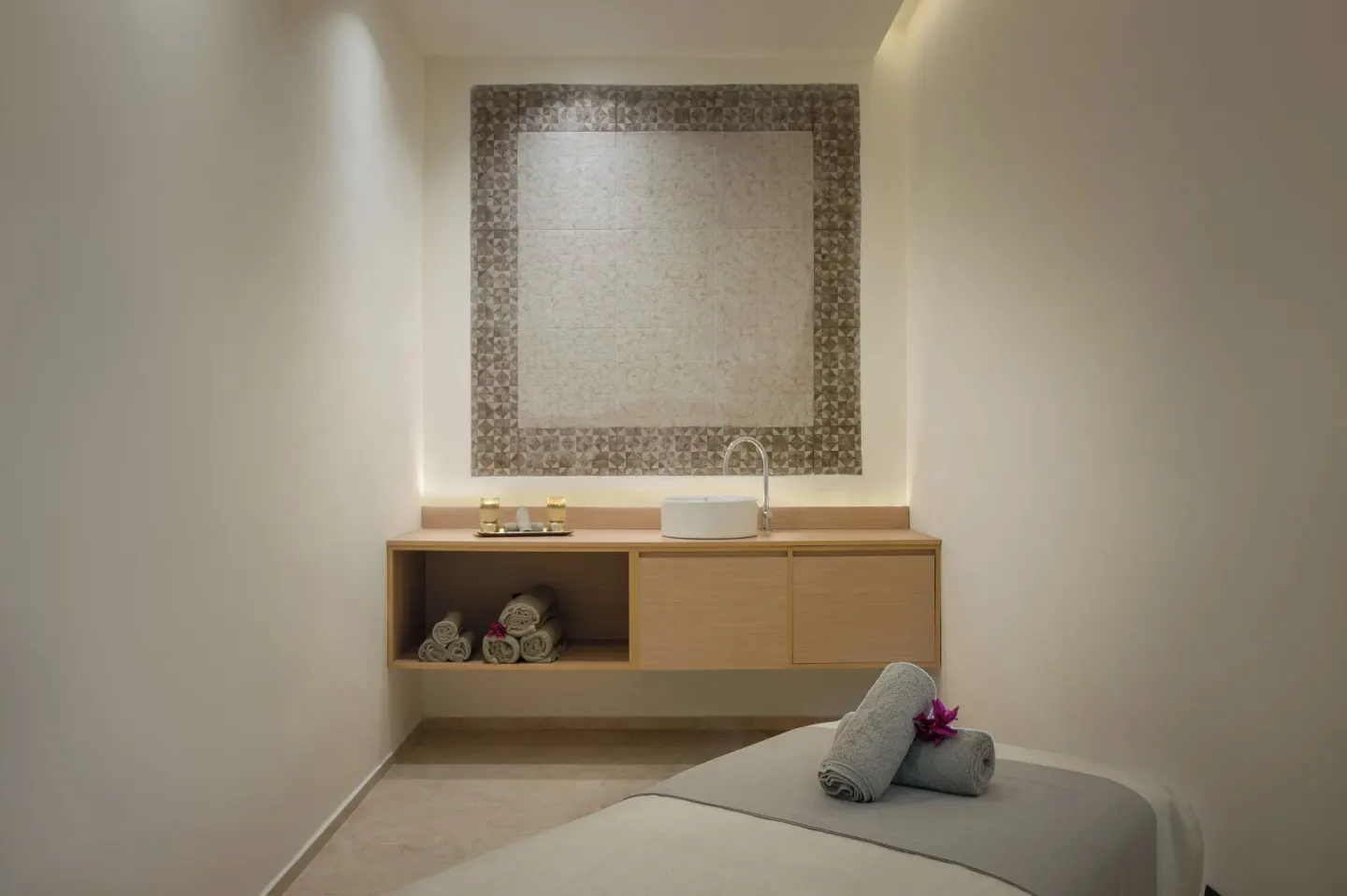 Single spa treatment room with massage table and sink at Live Aqua Punta Cana.