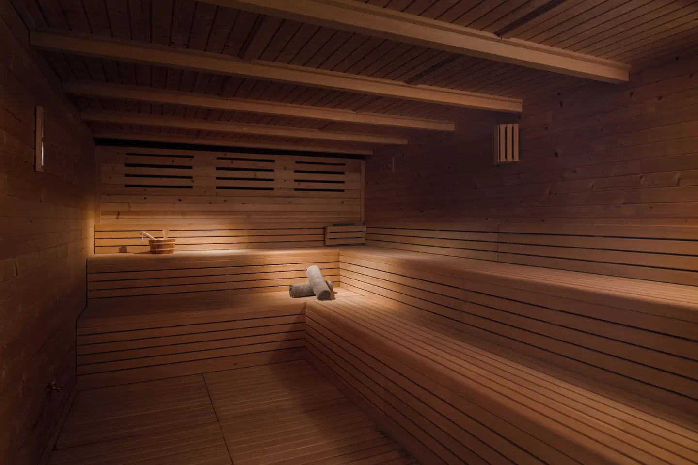 Wood-paneled sauna with tiered benches and warm lighting at Live Aqua Punta Cana.