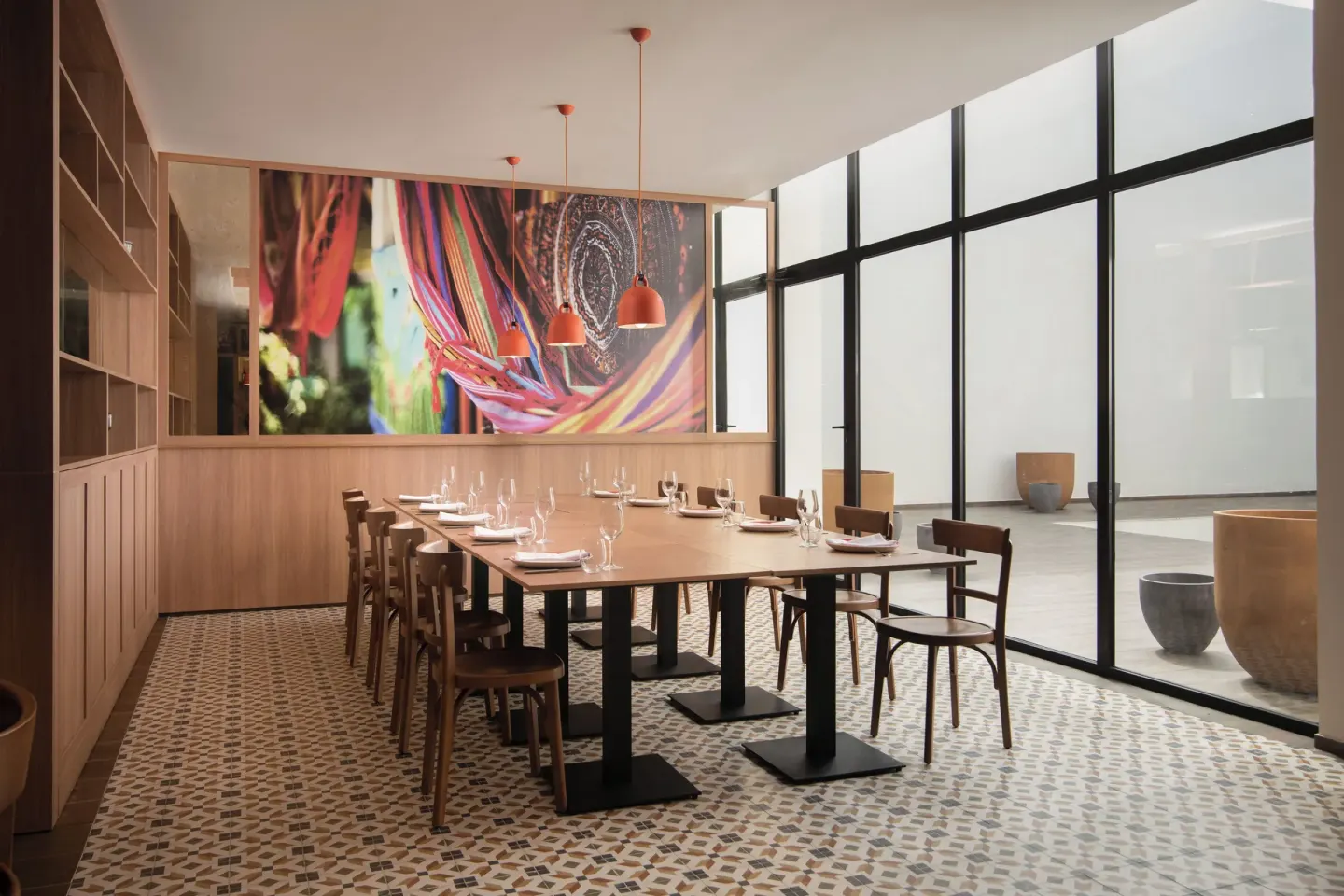 Private dining room with a long set table and colorful wall art at Live Aqua Punta Cana.