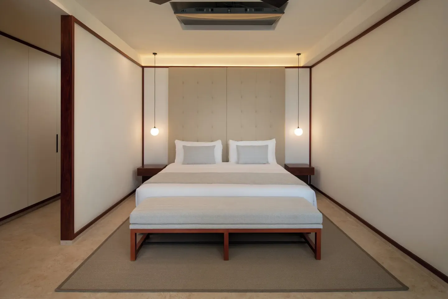 Fuego Suite Partial Ocean View king bed and bench at Live Aqua Punta Cana.
