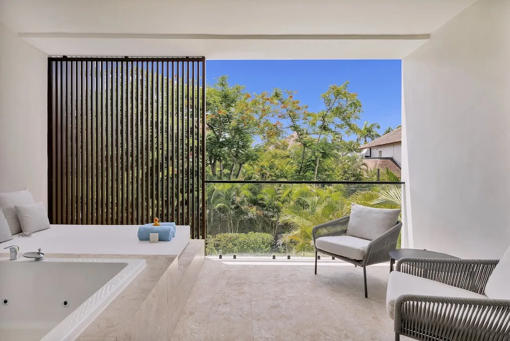 Junior Suite balcony with soaking tub and garden view at Live Aqua Punta Cana.