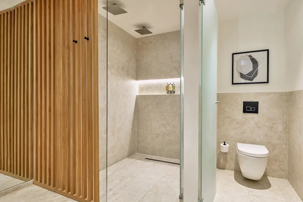 Junior Suite bathroom shower and toilet area at Live Aqua Punta Cana.