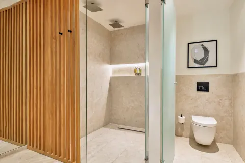 Walk-in shower and toilet in a Junior Suite Deluxe Pool View at Live Aqua Punta Cana.