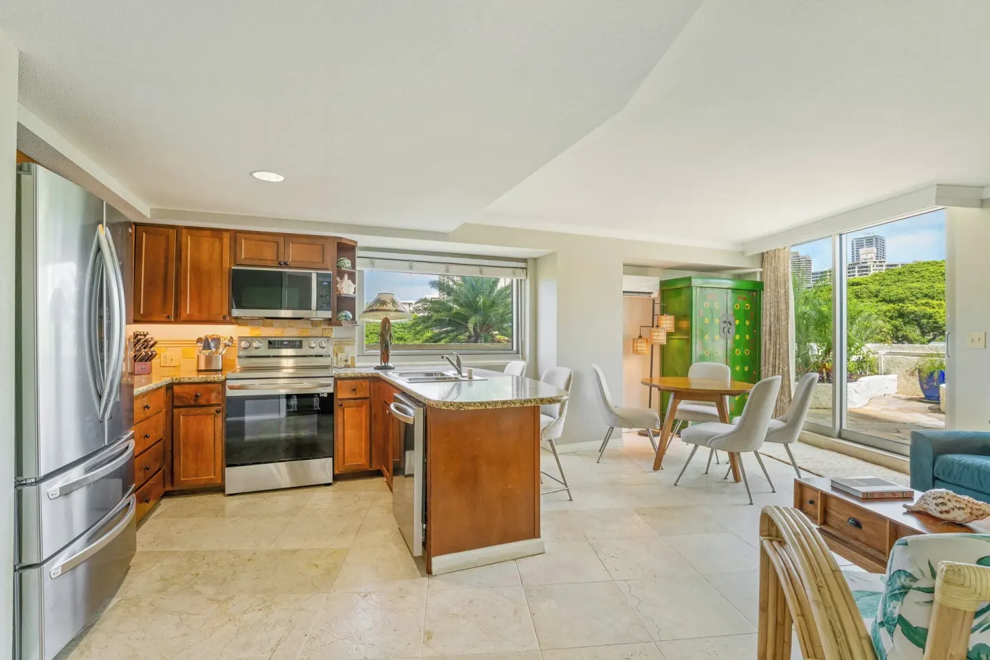 Suite kitchen and dining area with sliding doors at Luana Waikiki Hotel & Suites.