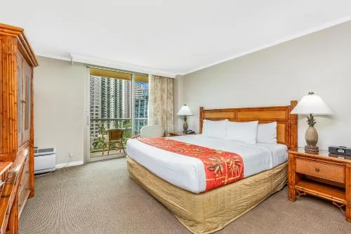 City View Two Bedroom Suite bedroom with king bed at Luana Waikiki Hotel & Suites.