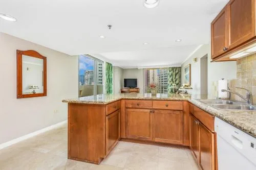 City View Two Bedroom Suite kitchen and living area at Luana Waikiki Hotel & Suites.
