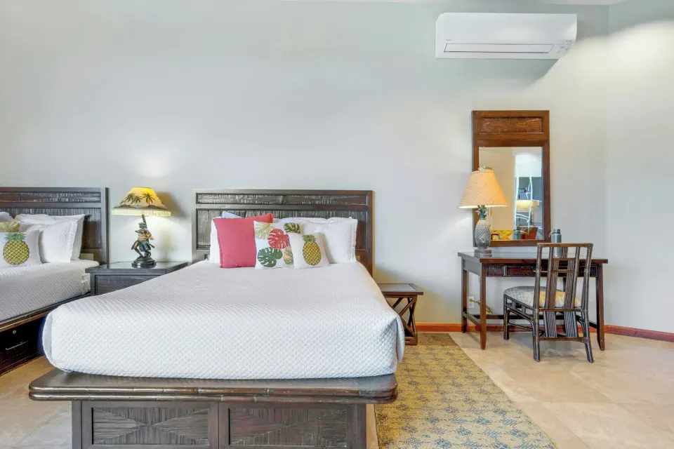 Mezzanine Level Studio Suite with two beds and a desk at Luana Waikiki Hotel & Suites.
