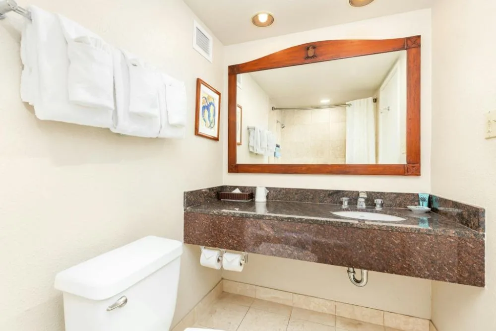 Partial Ocean View Studio Suite bathroom vanity at Luana Waikiki Hotel & Suites.