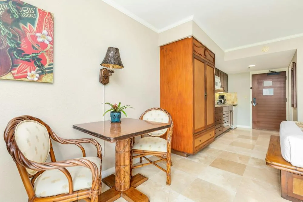 Partial Ocean View Studio Suite dining nook and kitchenette at Luana Waikiki Hotel & Suites.