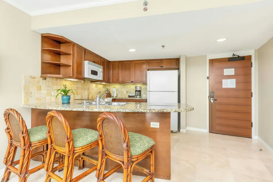 One-bedroom kitchen suite breakfast bar and full kitchen at Luana Waikiki Hotel & Suites.
