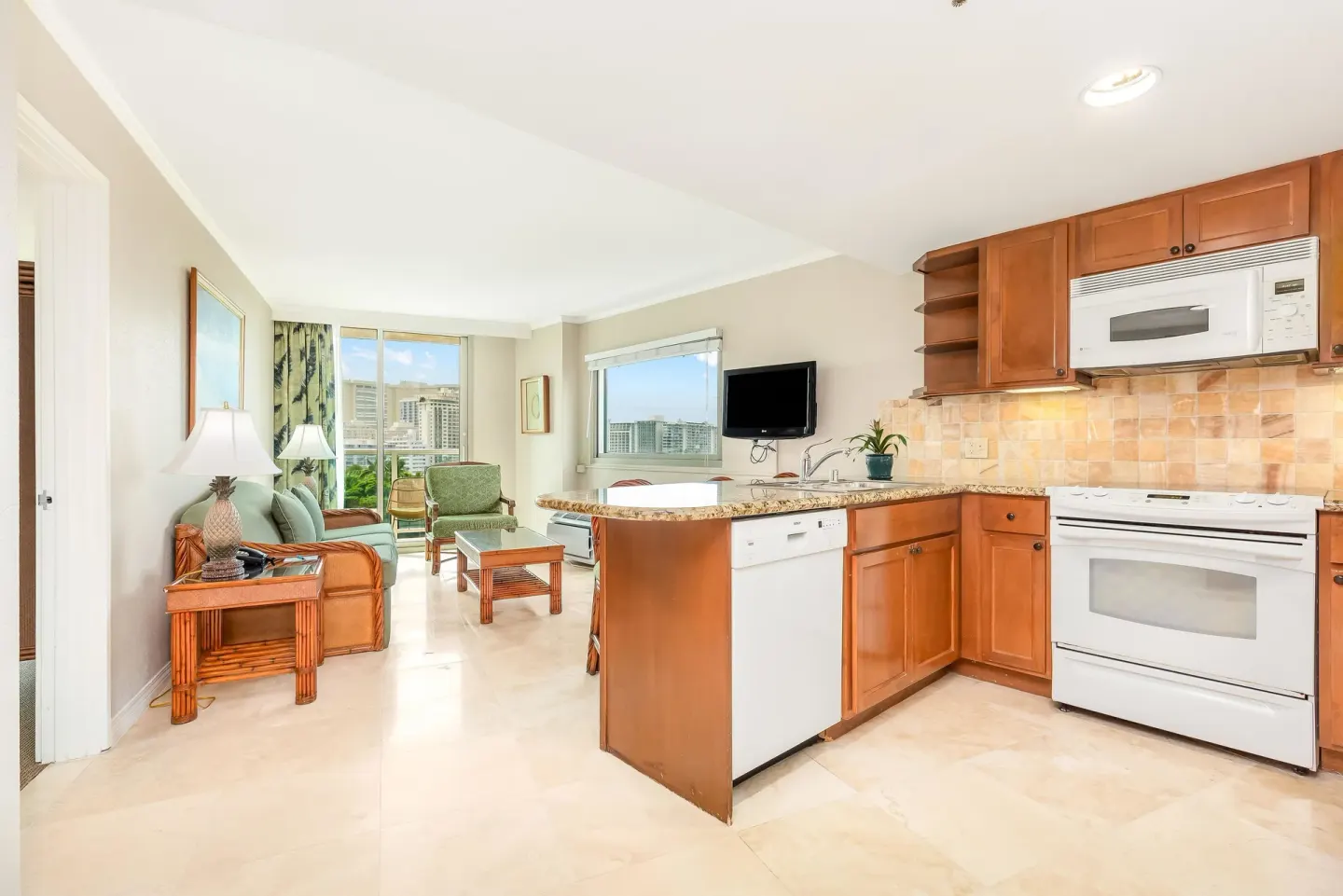 One-bedroom kitchen suite kitchen and living room with sofa bed at Luana Waikiki Hotel & Suites.