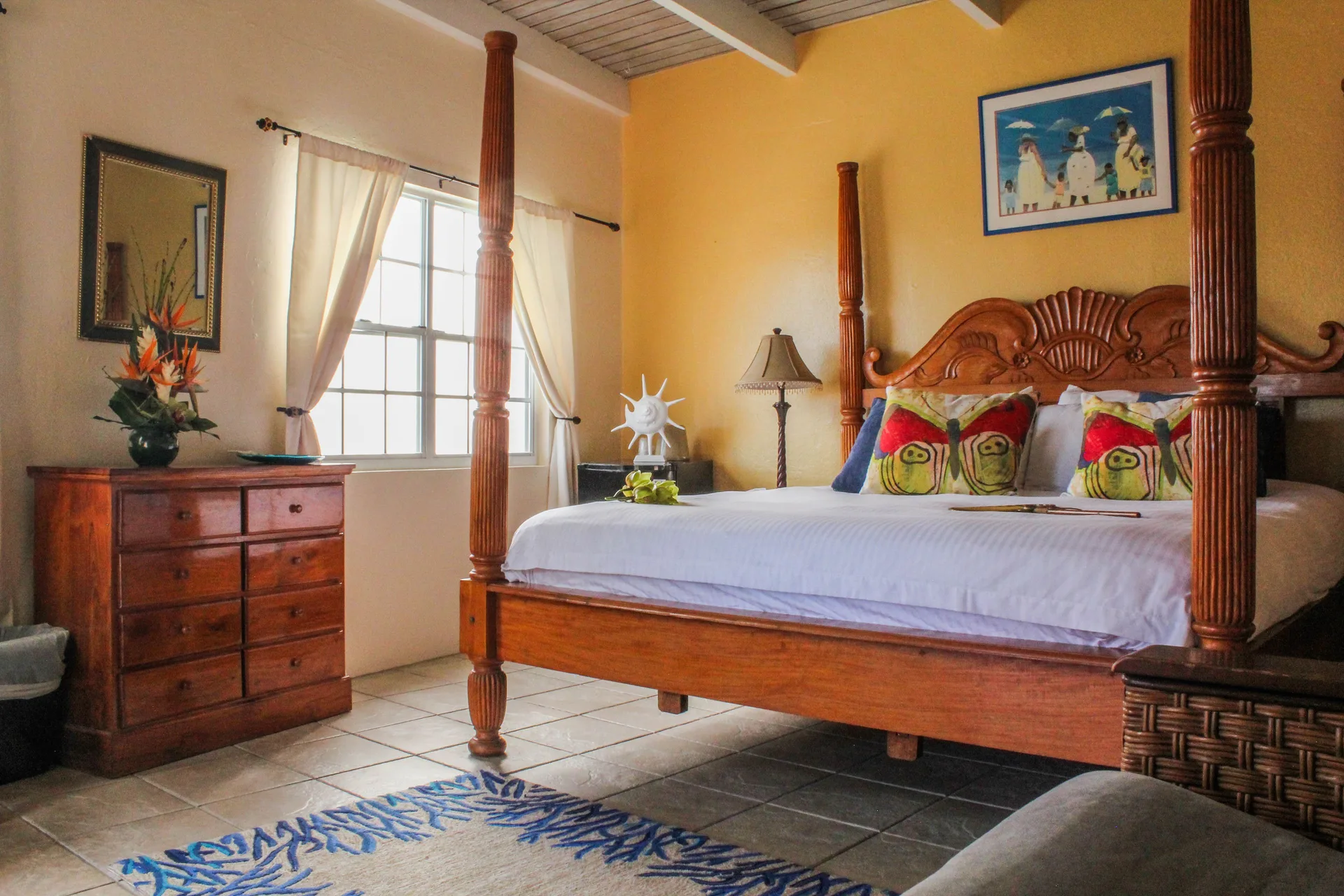 Guest room with a carved four-poster bed and dresser at Mafolie Hotel.