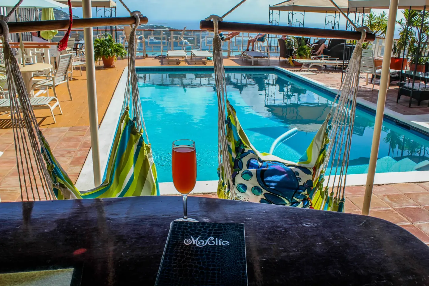 Hammock chairs and a drink overlooking the Mafolie Hotel pool.