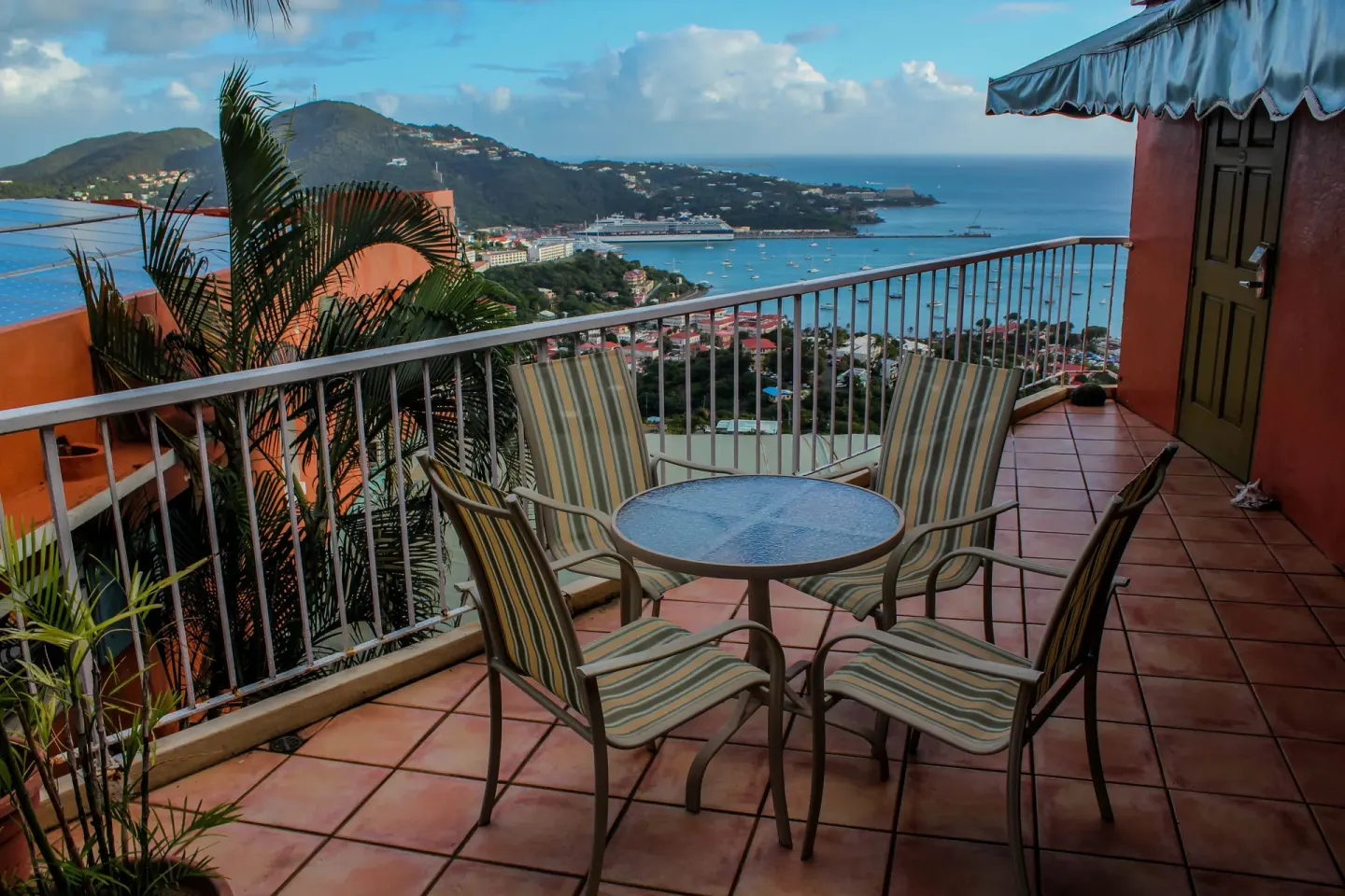 A balcony table and chairs overlook the harbor at Mafolie Hotel.