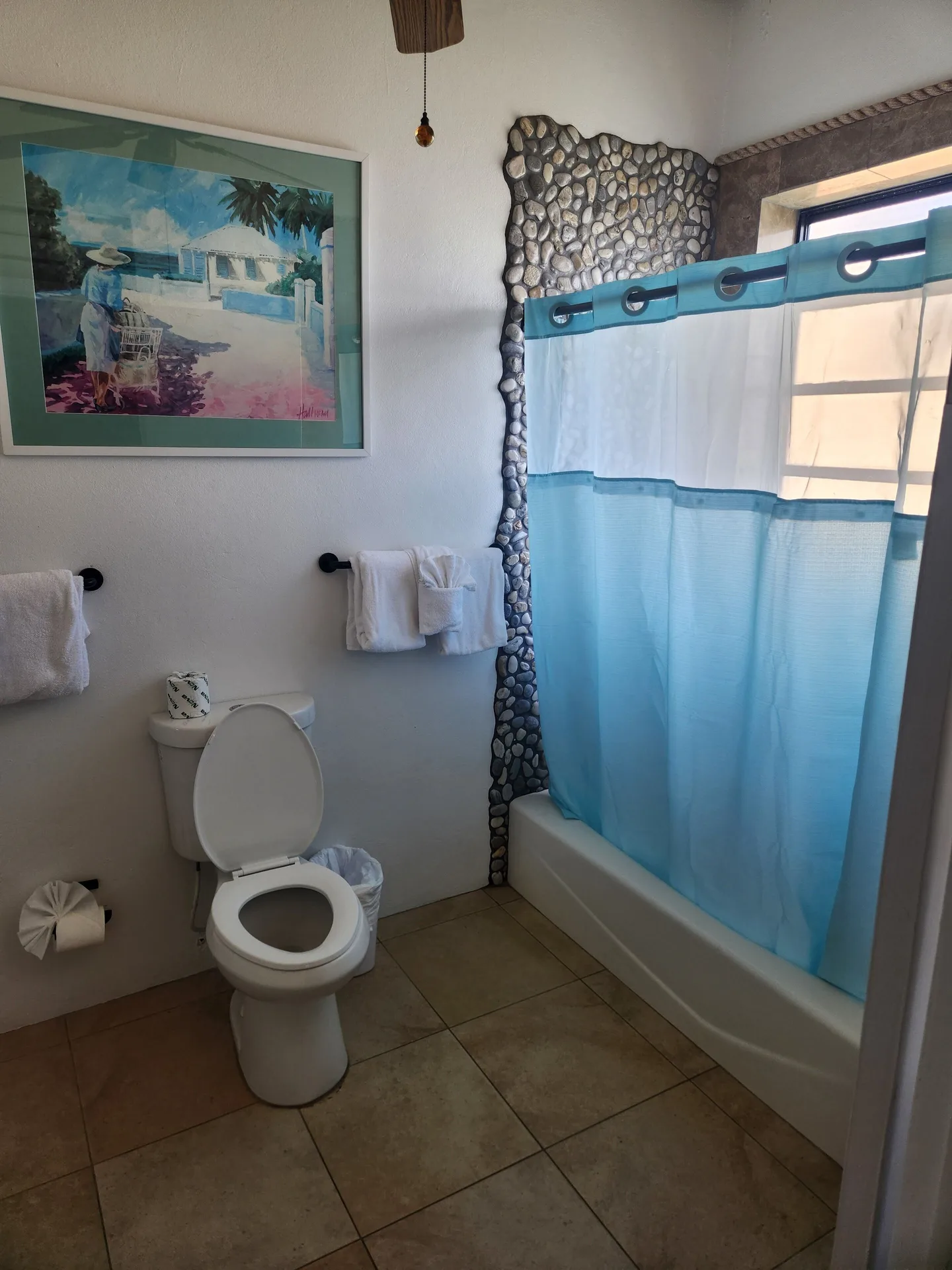 Panoramic Villa bathroom with tub, blue shower curtain, and toilet at Mafolie Hotel.