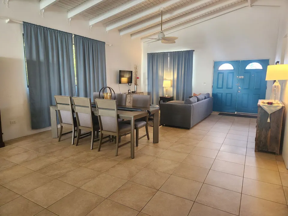 Panoramic Villa open living and dining area with blue entry doors at Mafolie Hotel.