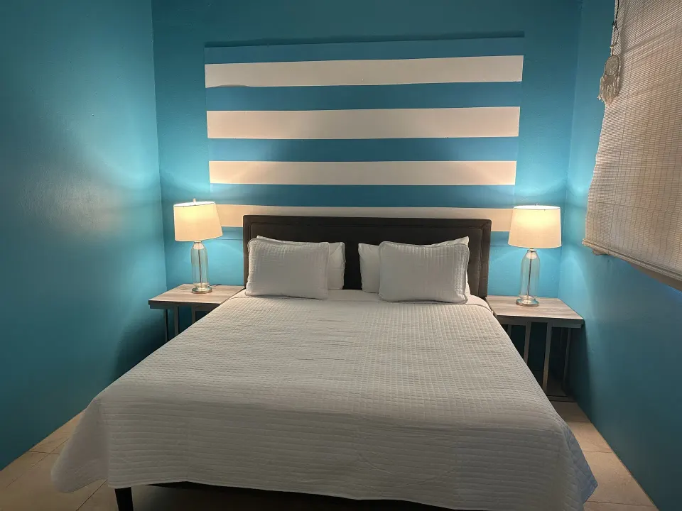 Panoramic Villa bedroom with white bed and blue walls at Mafolie Hotel.
