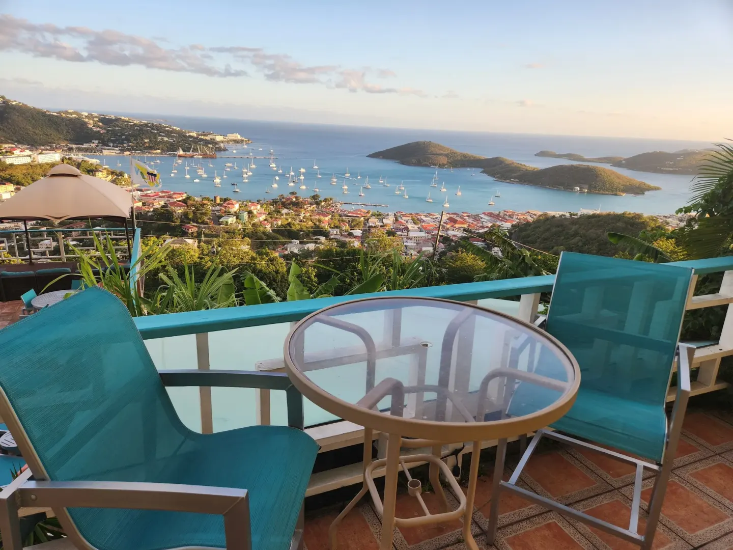 Balcony seating with harbor and island views from the Tiny Room at Mafolie Hotel.