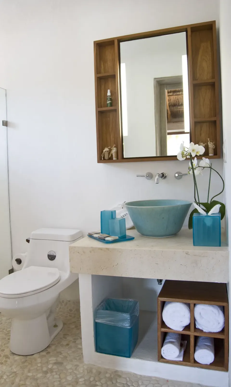 Resort bathroom vanity with turquoise bowl sink and toilet at Mahekal Beach Front Resort & Spa
