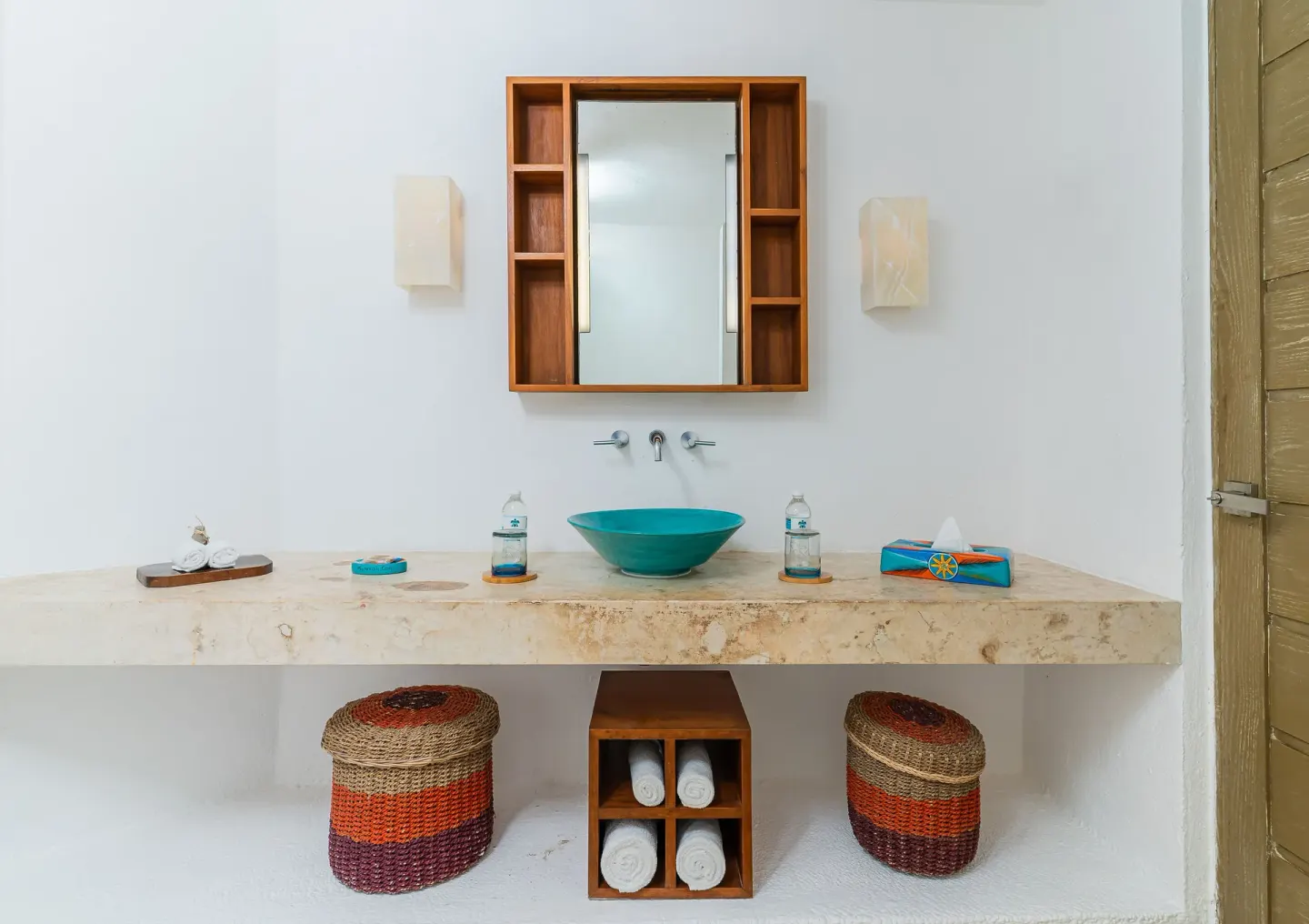 Guest bathroom vanity with turquoise sink at Mahekal Beach Front Resort & Spa.