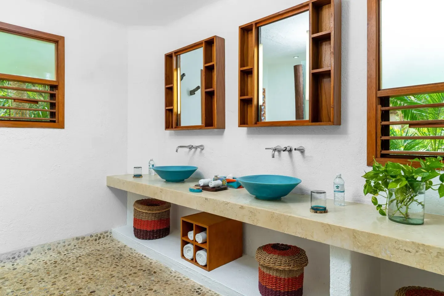 Spacious bathroom with twin turquoise sinks at Mahekal Beach Front Resort & Spa.