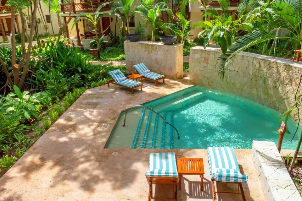 Private plunge pool surrounded by tropical planting at Mahekal Beach Front Resort & Spa