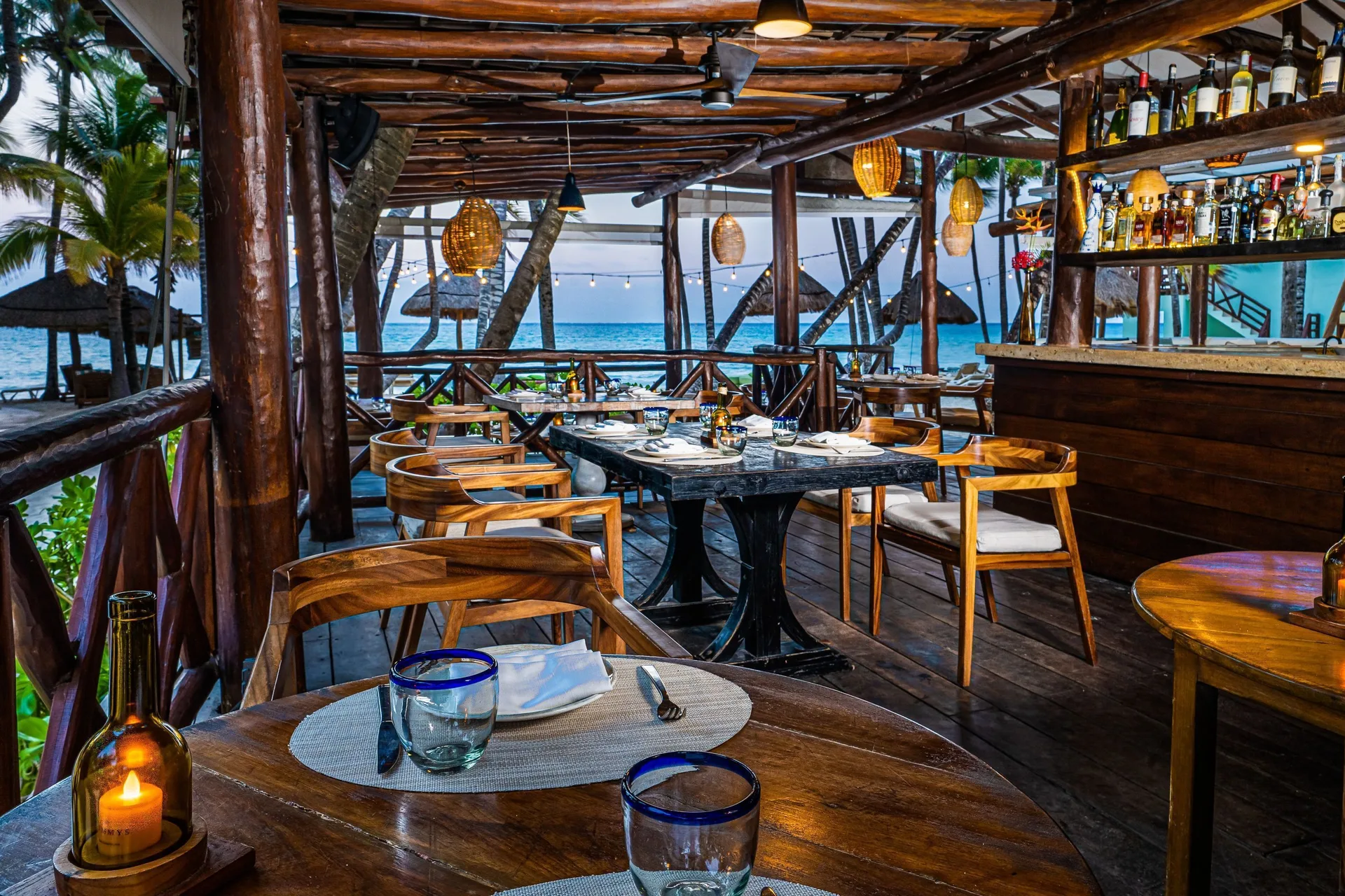 Oceanfront dining terrace and bar at Mahekal Beach Front Resort & Spa.