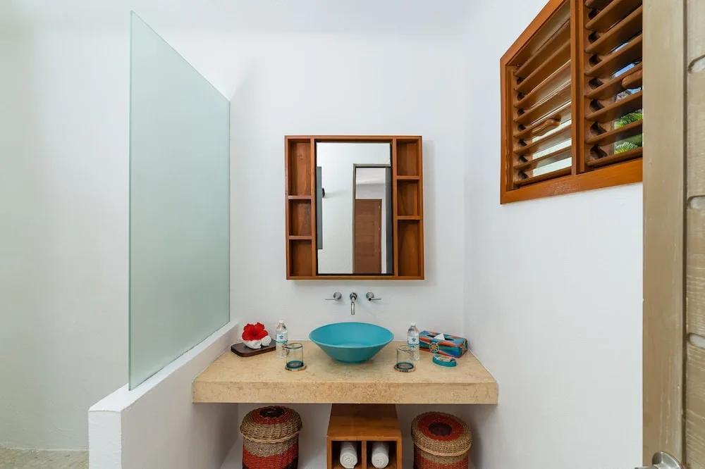 Garden View bathroom vanity with blue basin at Mahekal Beach Front Resort & Spa.