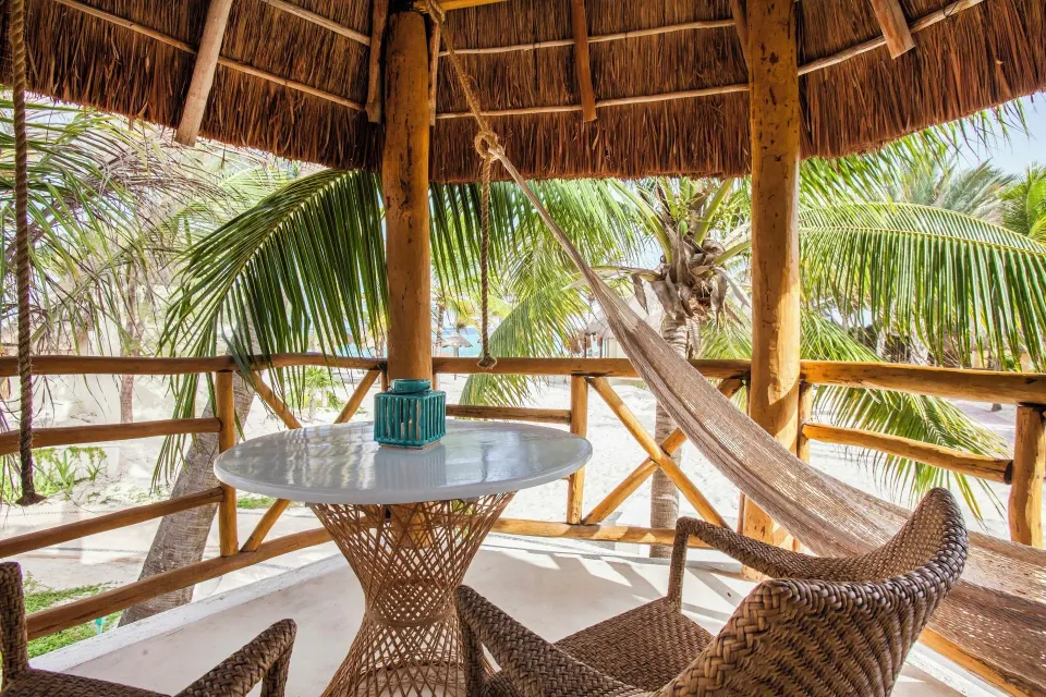 Ocean View Palapa private balcony with hammock and table at Mahekal Beach Front Resort & Spa