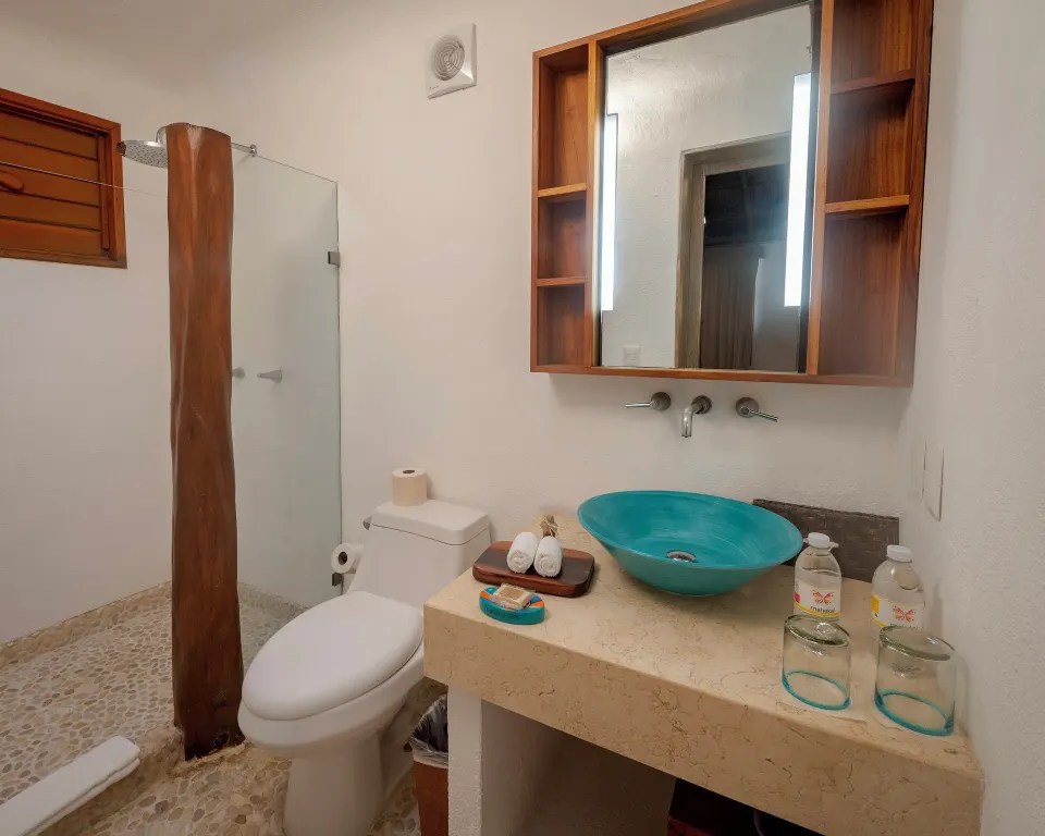 Bathroom of Ocean View Palapa Room with turquoise sink at Mahekal Beach Front Resort & Spa