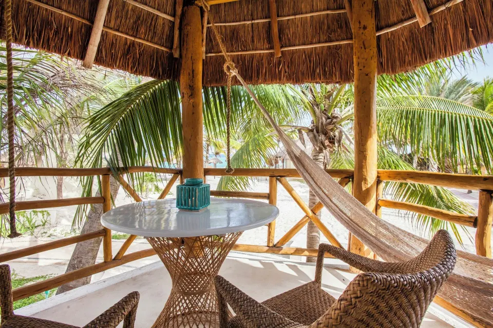 Ocean View Palapa terrace with hammock and palm-framed beach view at Mahekal Beach Front Resort & Spa.