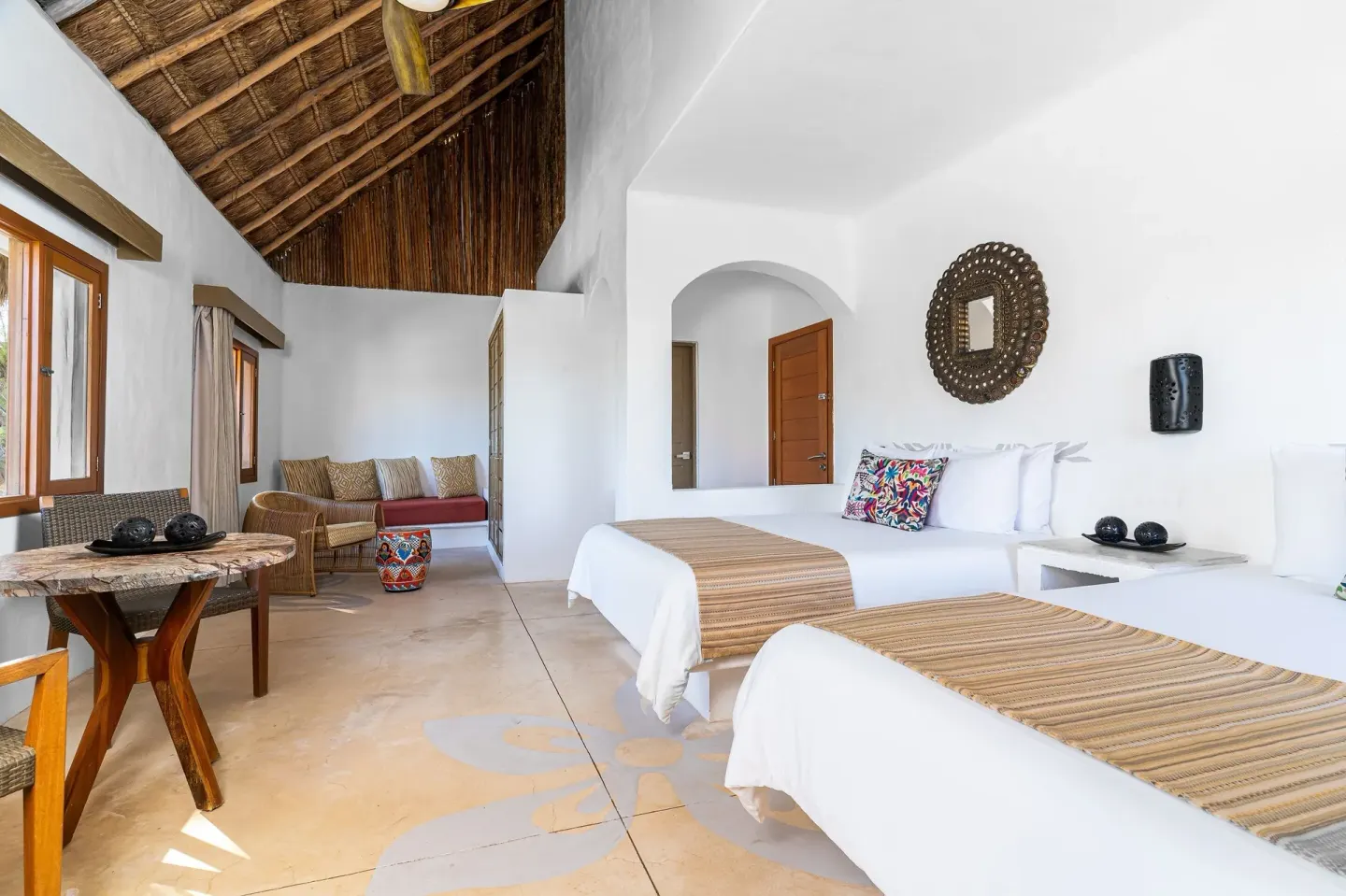 Ocean View Palapa room with two beds and seating at Mahekal Beach Front Resort & Spa.