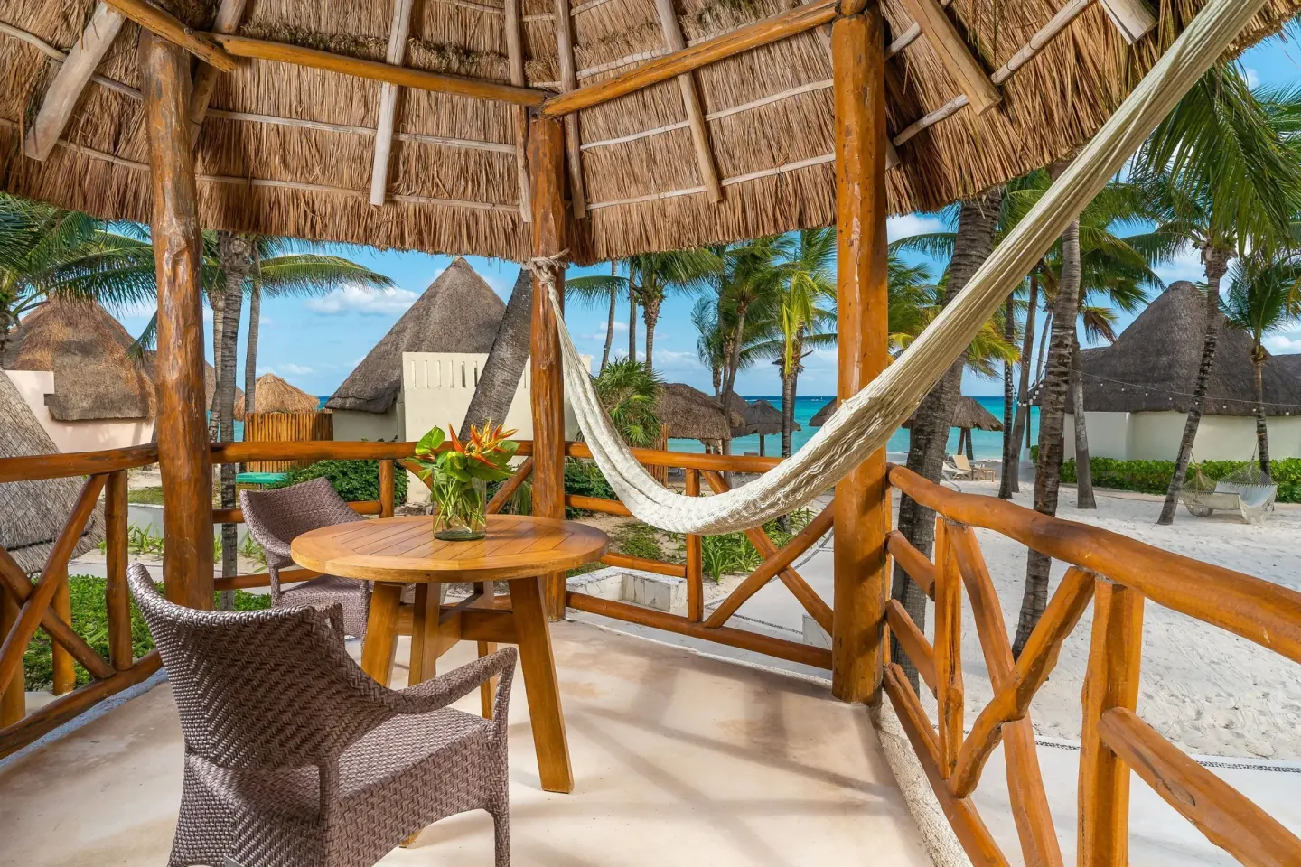 Ocean View room balcony with hammock and beach view at Mahekal Beach Front Resort & Spa.