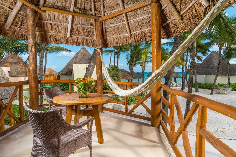 Ocean View room balcony with hammock and beach view at Mahekal Beach Front Resort & Spa.