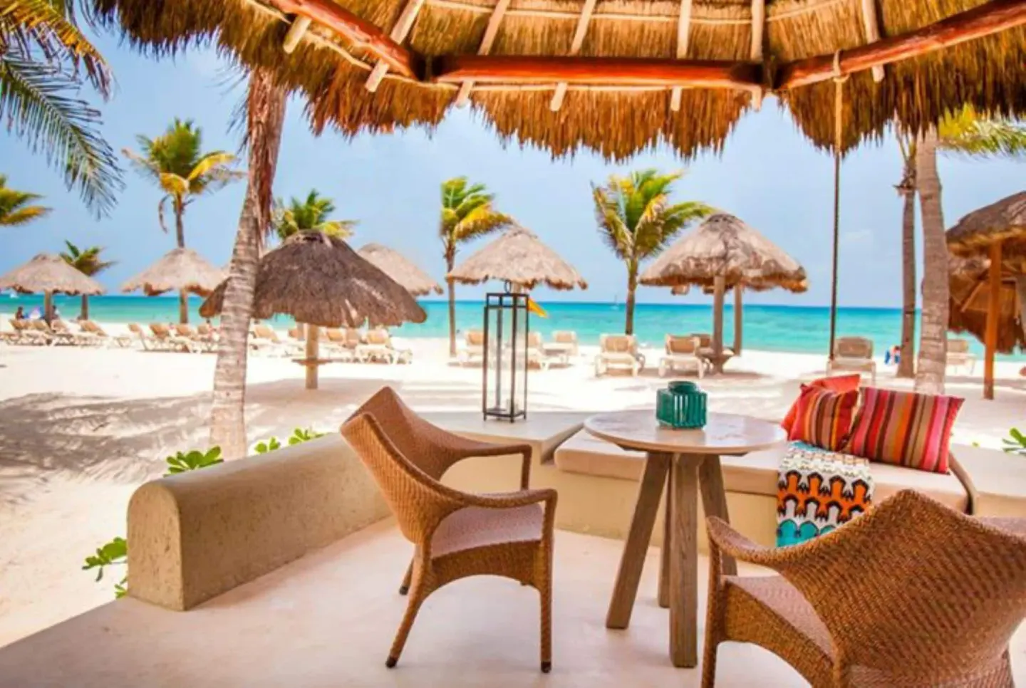 Ocean View room terrace with lounge seating by the beach at Mahekal Beach Front Resort & Spa.